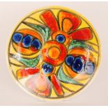 Poole Pottery - A large Delphis charger decorated with brightly coloured abstract patterns against
