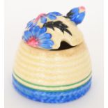 Clarice Cliff - Marguerite - A Beehive honey pot circa 1934, with a relief moulded cover decorated