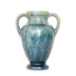 Pierrefonds - An early 20th Century twin handled vase of footed baluster form,