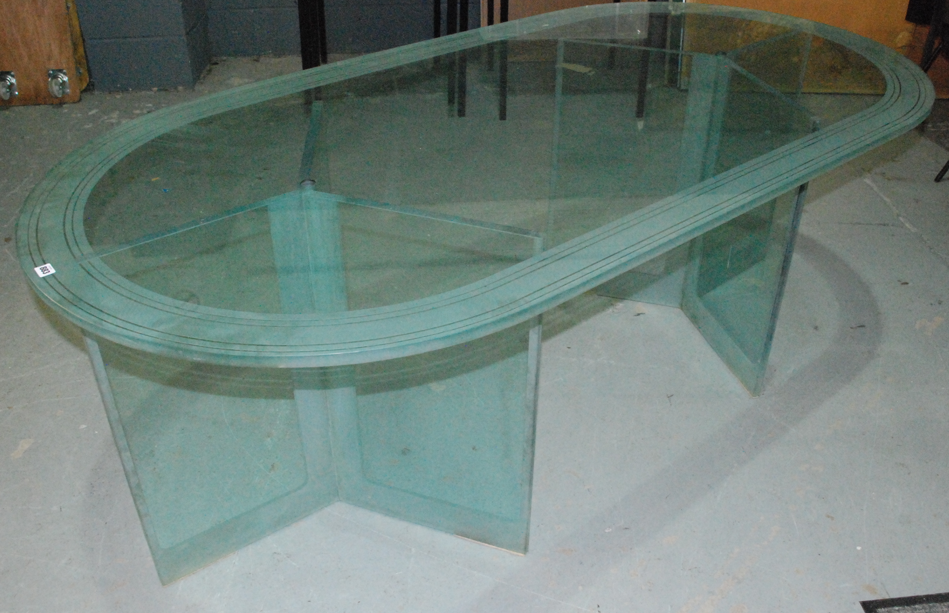 Peter Lord RIBA - T&W Ide Docklands - A large late 20th Century glass table with oval top raised to