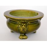 Bretby - An early 20th Century jardiniere, the body decorated with three relief moulded lion heads