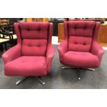 Unknown - A pair of swivel armchairs, with button down striped plum coloured upholstery over