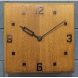 In the manner of Heals - A 1930s oak wall clock of square form with copper numerals, probably
