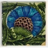 William de Morgan - BBB - A Sands End 8in plastic clay tile decorated with a large blue flower and