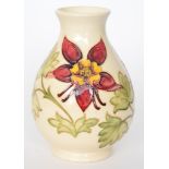 A Moorcroft Pottery baluster vase decorated in the Columbine pattern with tubelined flowers and