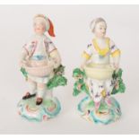 A pair of 18th Century Derby figures of Dessert Gardeners both standing before flowering bocages