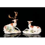 A pair of 18th Century Derby figurines modelled as a recumbent deer and stag both with hand painted