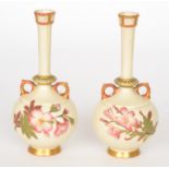 A pair of 19th Century Royal Worcester blush ivory twin handled vases,