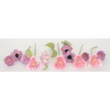 A 20th Century porcelain floral arrangement comprising fourteen purple stem flowers to include