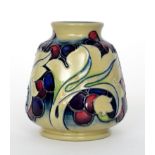 A Moorcroft Pottery Trial vase decorated with a leaf and berry design,