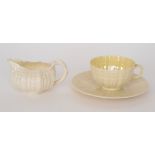 A late 19th to early 20th Century Belleek Second Period teacup and saucer relief moulded as shells