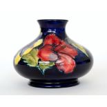 A Moorcroft vase of compressed ovoid form decorated in the Hibiscus pattern with three tubelined