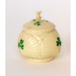 A Belleek third period mustard pot of ovoid form modelled as four clam shells with hand painted