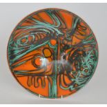 A Poole Pottery Delphis bowl decorated with oxidised and copper green brush strokes against an