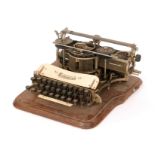 A Hammond No 12 typewriter in an oak case and base,