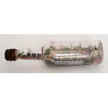 A 19th Century ship in a bottle of a wooden schooner,