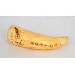 A 19th Century scrimshaw marine tooth carved with ring dot decoration, height 9.5cm.