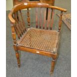 A 20th Century beech corner chair slat back over a cane seat on turned legs together with a spindle