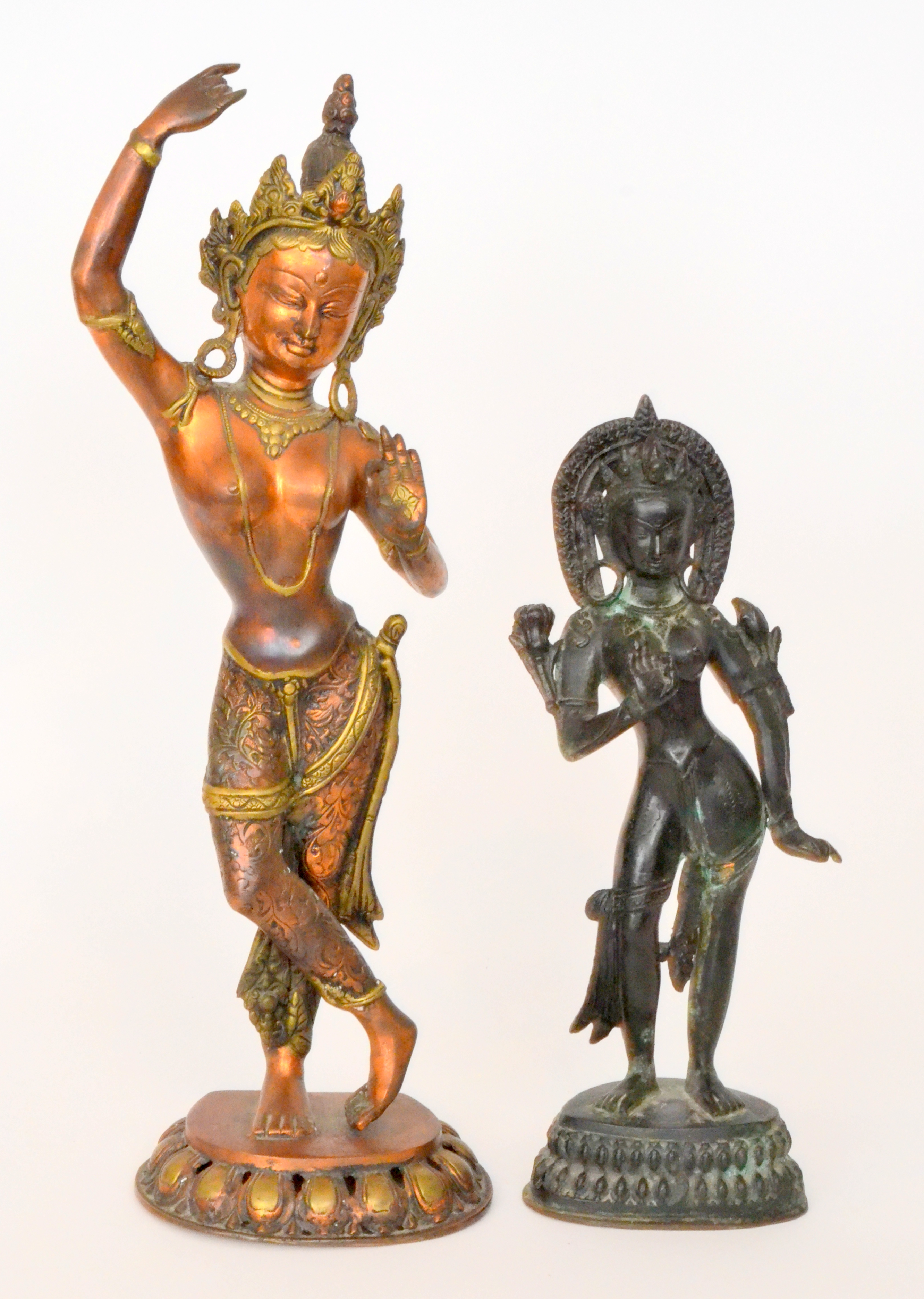 A 20th Century copper and brass Indonesian statue of a dancing goddess wearing a headdress,