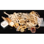 A small parcel lot of costume jewellery to include silver pendants, gold tone rings and necklaces,