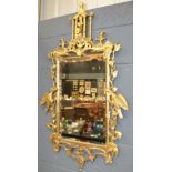 A 20th Century Chinese Chippendale style gilt wall mirror with pagoda pediment above two Ho Ho