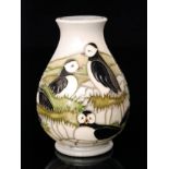 A Moorcroft Pottery Puffin pattern baluster vase designed by Carole Lovet and decorated with