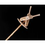 A rose gold coloured stick pin in the form of a pair of crossed cricket bats with gem set cricket
