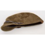 A WWII Japanese officers felt cap in khaki green with yellow star and leather band.