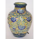 A 20th Century stoneware baluster vase decorated with a repeat pattern of blue flower heads and
