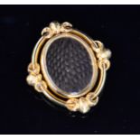 A 19th Century memorial swivel brooch with plaited hair to one side and vacant panel to the other,