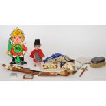A small German bisque head doll in Welsh costume together with a novelty painted wall clock of a