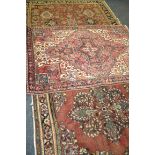 A 20th Century North West Persian rug the central diamond lozenge design within a multi running
