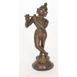 An early 20th Century bronze figure of Lord Krishna playing a flute, height 16cm.