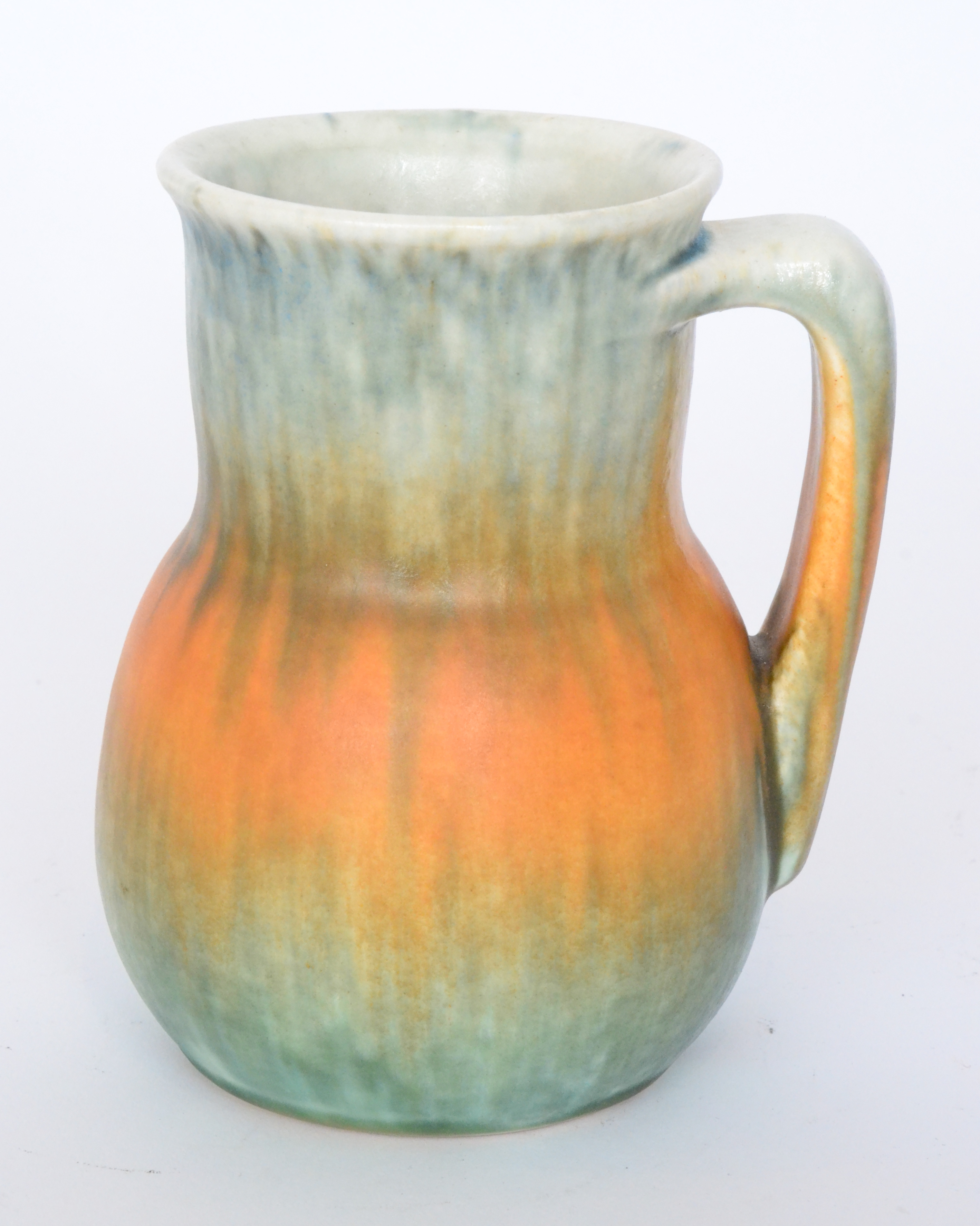 A Ruskin Pottery crystalline glaze flower jar decorated with a streaked pale green and orange glaze,