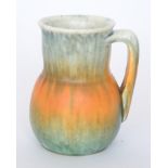 A Ruskin Pottery crystalline glaze flower jar decorated with a streaked pale green and orange glaze,