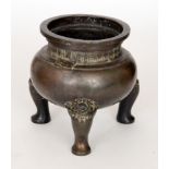 A 19th Century Chinese bronze censer of bulbous circular form raised on three Fo dog mask legs,