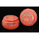 A pair of 20th Century Chinese carved cinnabar lacquered jars and covers of squat bulbous form