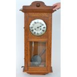 An early 20th Century oak eight day strike wall clock,