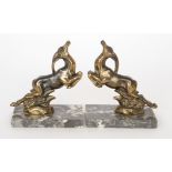 A pair of French Art Deco cast stylized brass models of prancing gazelles,