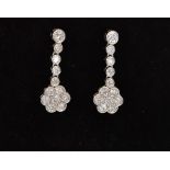 A pair of 18ct white gold diamond daisy drop earrings,