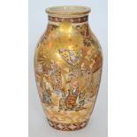 A late 19th to early 20th Century Satsuma baluster vase decorated with cartouche panels of robed