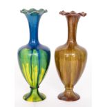 Two similar 19th Century Linthorpe Pottery vases each of footed baluster form with tall flared