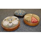 A pair of Victorian circular footstools each with and embroidered and Berlin beadwork top together