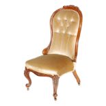 A Victorian mahogany spoon back easy chair upholstered in gold plush on cabriole legs to the front.