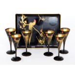 A Chinoiserie black lacquer cocktail set comprising six glasses to a rectangular tray,