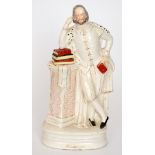 A large 19th Century Staffordshire flatback of William Shakespeare stood leaning on a pedestal with