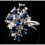 A modern 14ct white gold sapphire and diamond cluster ring, of abstract foliate design,