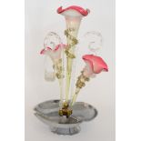 A late 19th Century Continental glass table centre epergne with a cast metal base rising to a