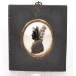 A 19th Century painted silhouette of a female wearing a bonnet in a sideways profile within an