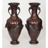 A pair of Meiji period bronze baluster twin handled vases each decorated with relief moulded birds